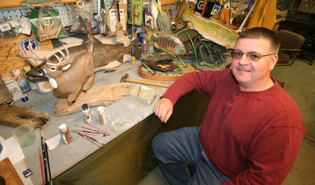 Joe McBrine poses with some of his work.