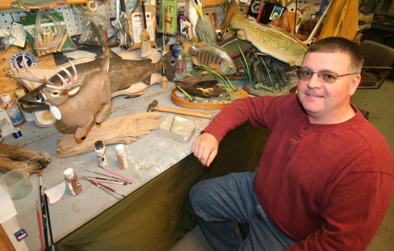 Joe McBrine poses with some of his work.