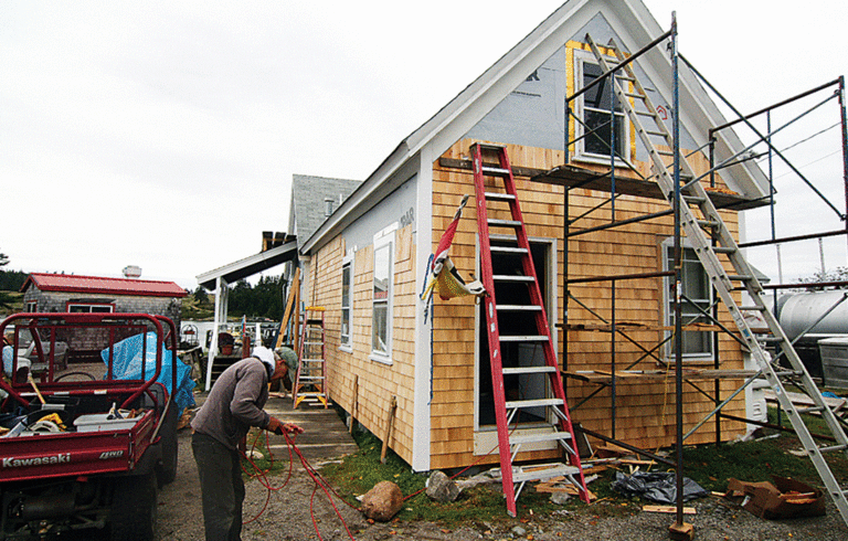 Volunteers pitch in to work on the store building.