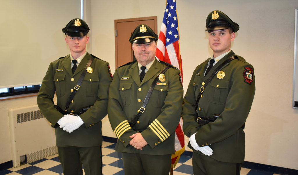 Marine patrol officers Jonathan Varnum (left) and Alex Hebert (right) pose with Col. Jonathan Cornish after graduating from the Maine Criminal Justice Academy on Dec. 15. Having previously completed the academy's pre-service program