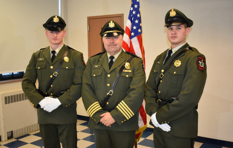 Marine patrol officers Jonathan Varnum (left) and Alex Hebert (right) pose with Col. Jonathan Cornish after graduating from the Maine Criminal Justice Academy on Dec. 15. Having previously completed the academy's pre-service program