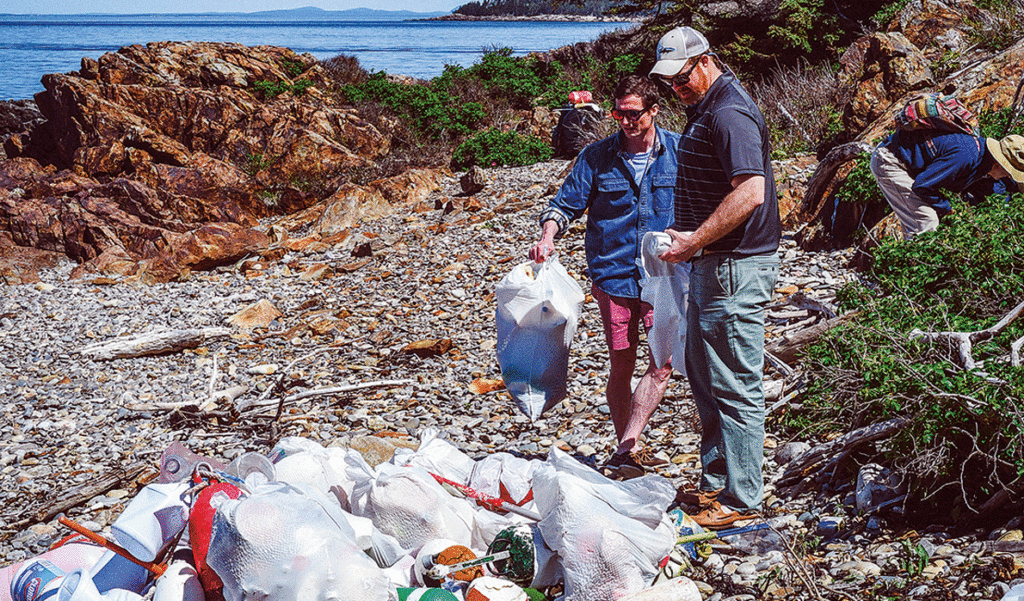 Volunteers pick up trash on a Midcoast island this summer.