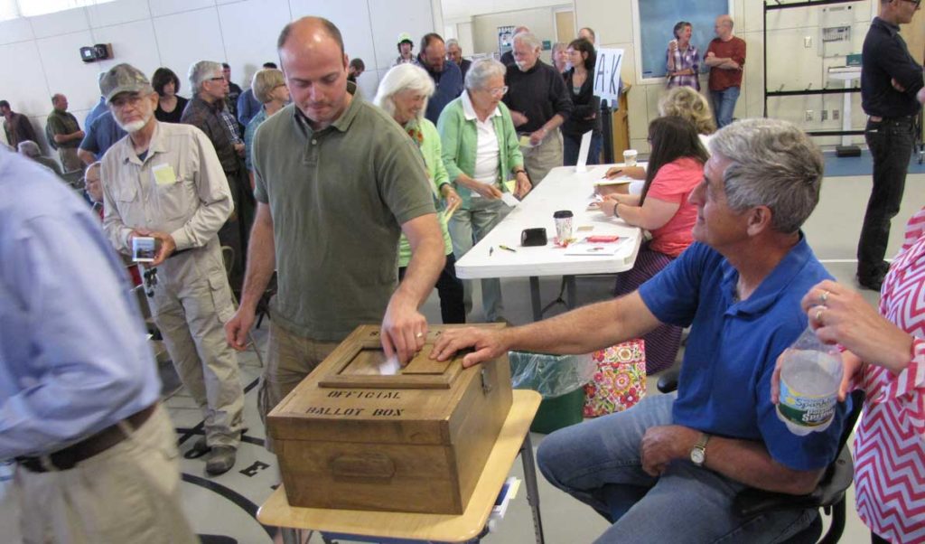 Jon Bolduc votes at Islesboro's annual town meeting on Saturday