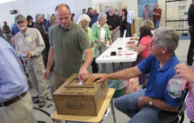 Jon Bolduc votes at Islesboro's annual town meeting on Saturday