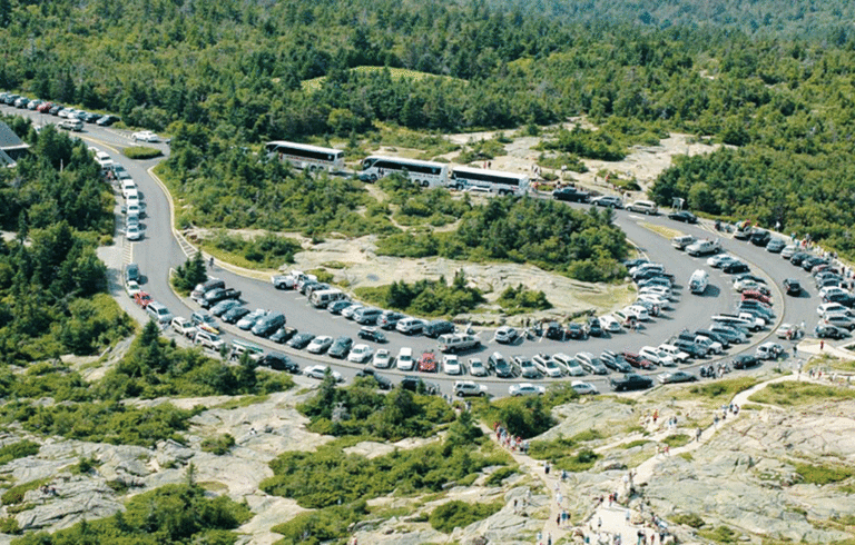 An aerial view of the summit of Cadillac Mountain in Acadia National Park shows cars circling