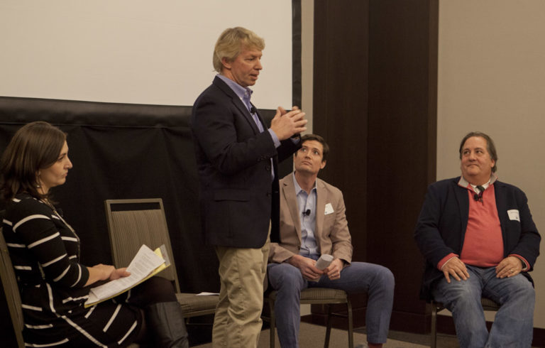 JB Turner of Belfast's Front Street Shipyard speaks at the Island Institute's Waypoints Forum in Portland on Jan. 19. At left is the Island Instiute's Briana Warner. At far right is Mark Ouellette of Axiom Technologies