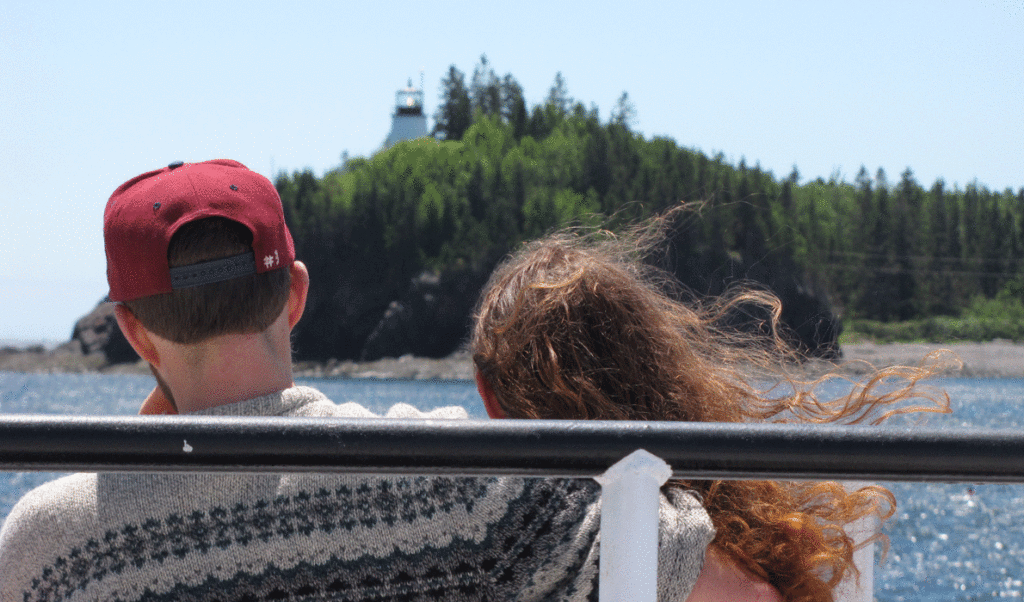 A couple enjoy the Maine State Ferry Service boat ride past Owls Head light on the way to Vinalhaven.