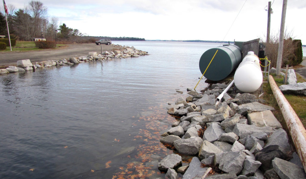 Fuel tanks sit close to the water during a high-tide event in Lincolnville Beach.