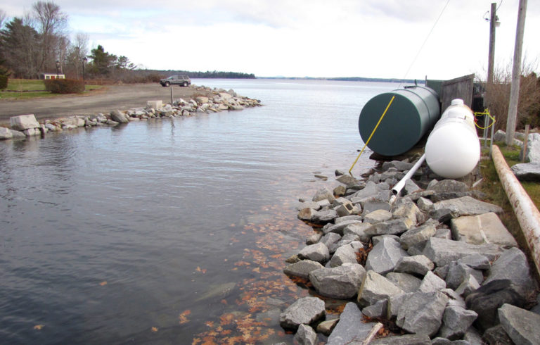 Fuel tanks sit close to the water during a high-tide event in Lincolnville Beach.