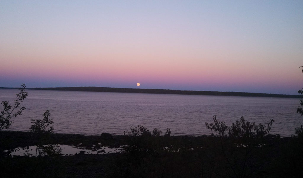 The full moon rises over Islesboro.