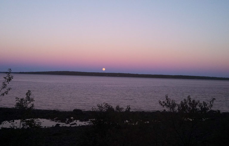 The full moon rises over Islesboro.