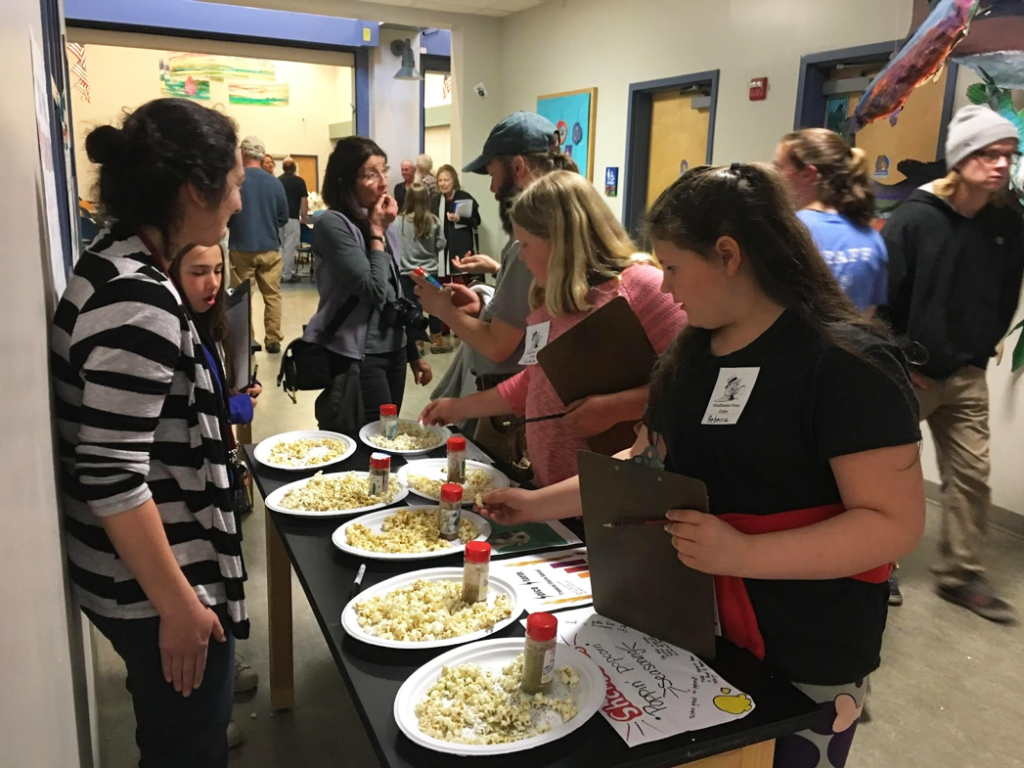 5th grade reporters working on a school newsletter sample kelp spice blends made by middle school students.