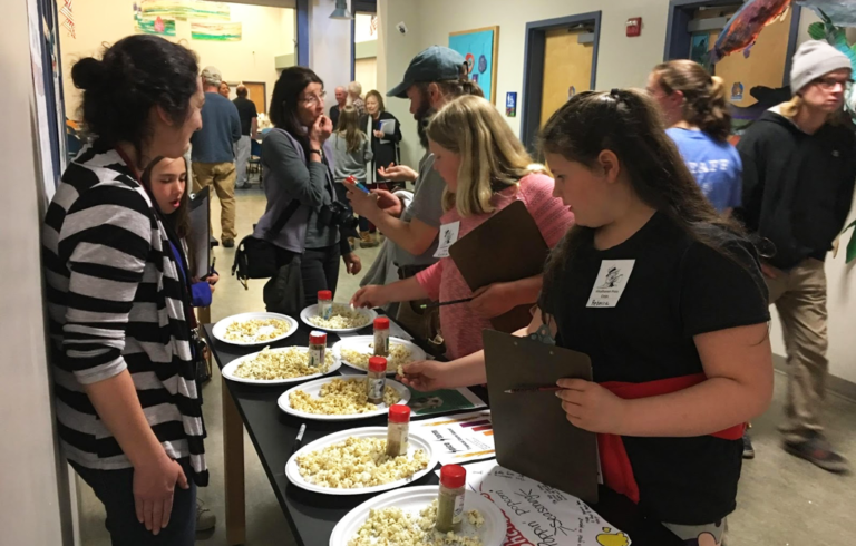 5th grade reporters working on a school newsletter sample kelp spice blends made by middle school students.