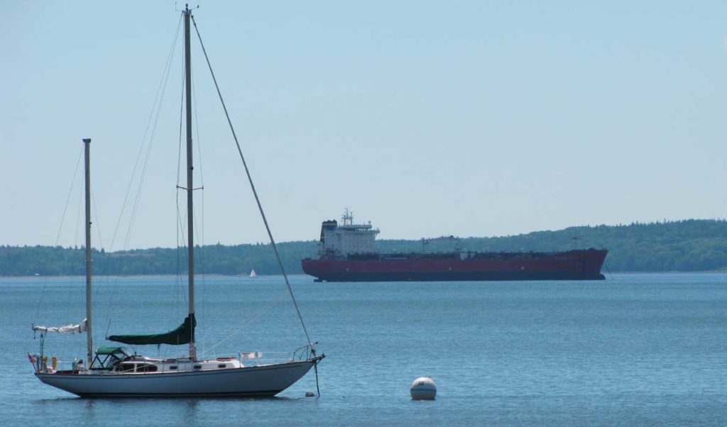 A sailboat and cargo ship share the waters off Searsport.