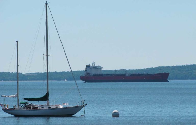A sailboat and cargo ship share the waters off Searsport.