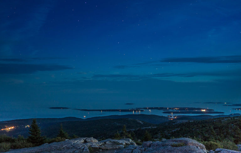 Night sky from Cadillac Mountain with the Cranberry Isles in view.