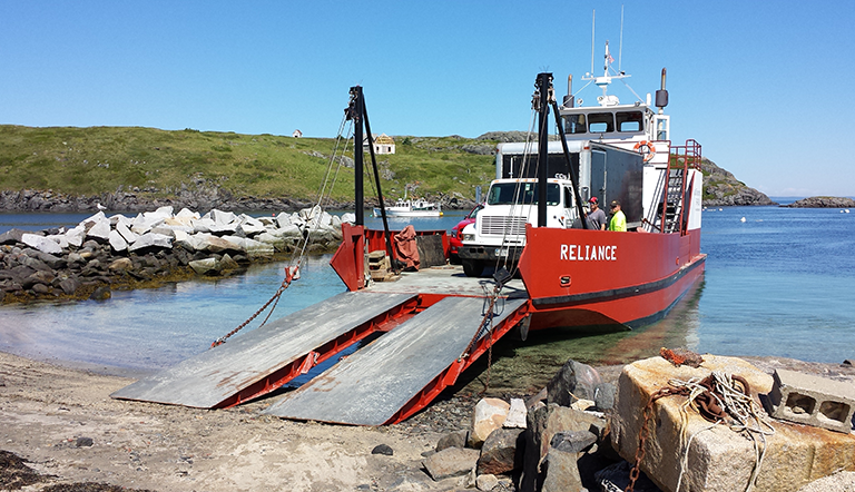 Unloading a spray foam insulation truck on Monhegan island during a Weatherization Week.