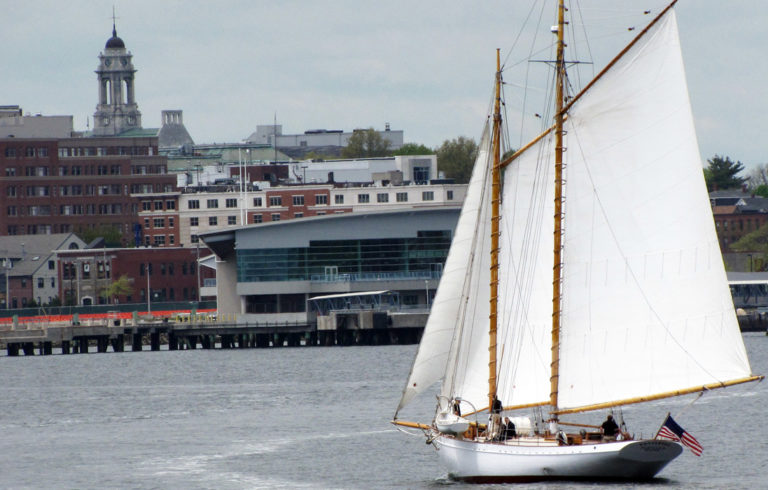 A sailboat approaches Portland's waterfront.