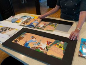 Merz demonstrates how she layered fabric and other material to create the Illustrations.