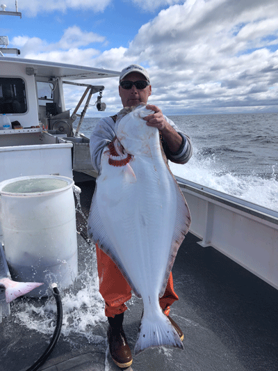 Port Clyde fisherman Gerry Cushman with a halibut. PHOTO: COURTESY CUSHMAN FAMILY