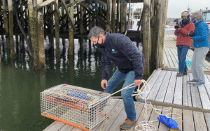 CAPTION: Friends of Casco Bay staff scientist Mike Doan launches a new continuous monitoring station in Harpswell. See story inside. PHOTO: COURTESY FRIENDS OF CASCO BAY 