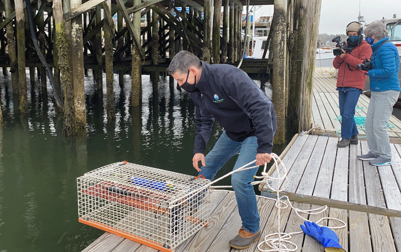 CAPTION: Friends of Casco Bay staff scientist Mike Doan launches a new continuous monitoring station in Harpswell. See story inside. PHOTO: COURTESY FRIENDS OF CASCO BAY