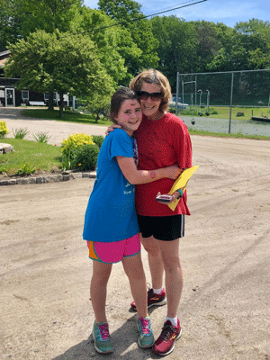 Happy, proud family hugs after completing the 5K.