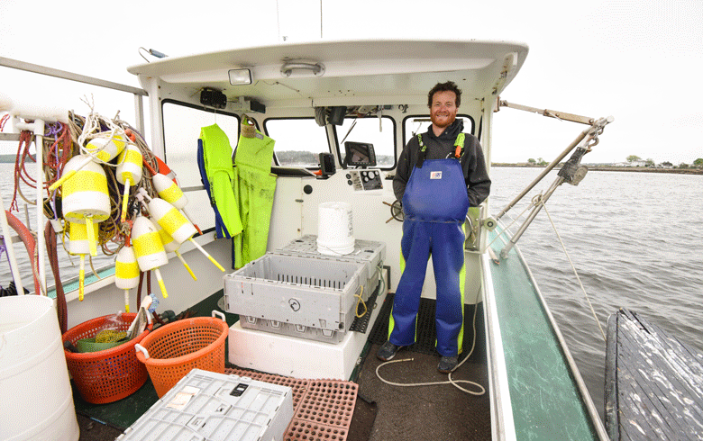 Ethan DeBery, owner of Fish 'n Trips, in Phippsburg aboard his AJ-28-foot lobster boat.