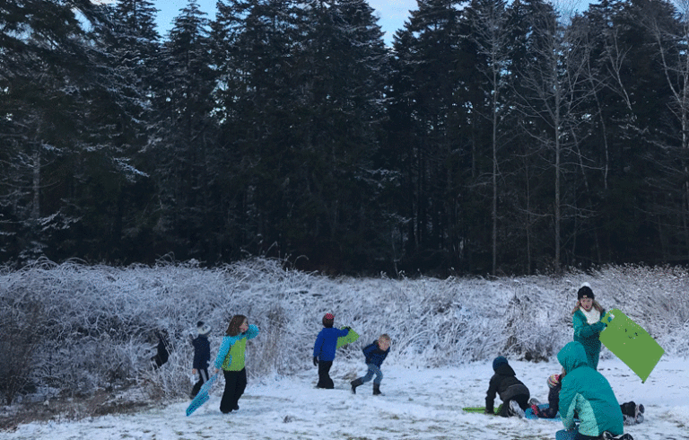 Students enjoy sledding after school.