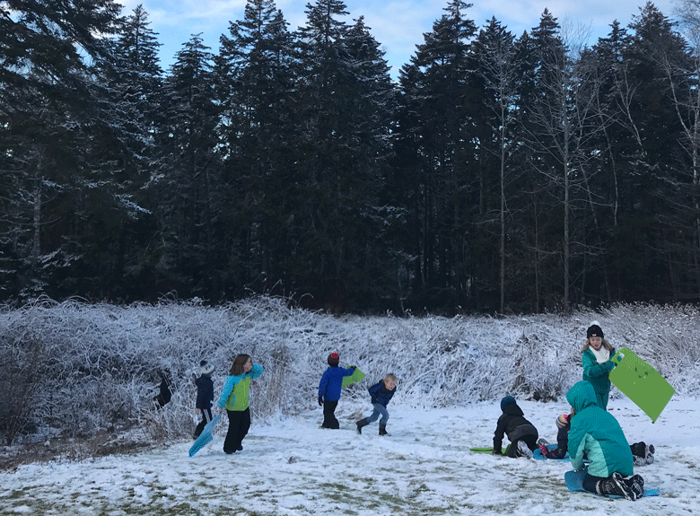 Students enjoy sledding after school.