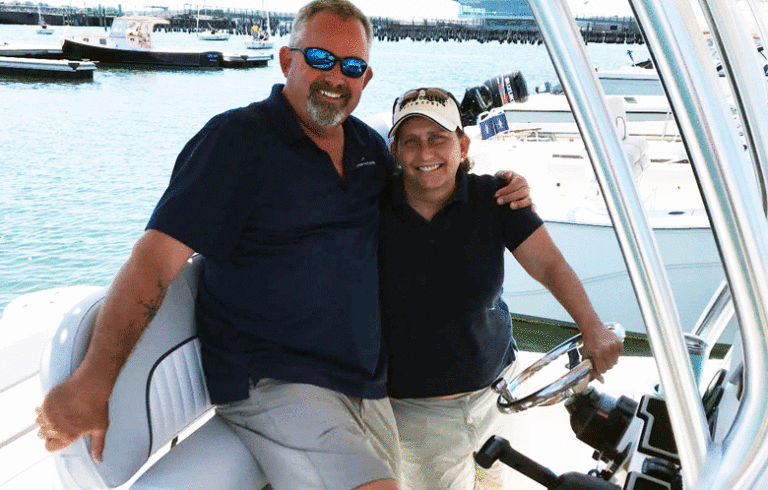 Vickie Ducharme, a member of Freedom Boat Club, poses with a trainer. PHOTO: COURTESY YARMOUTH BOAT YARD.