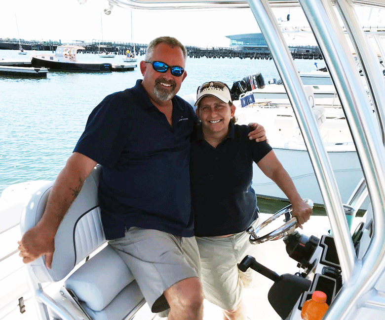 Vickie Ducharme, a member of Freedom Boat Club, poses with a trainer. PHOTO: COURTESY YARMOUTH BOAT YARD.