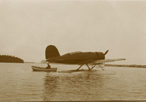 Alfred Burke guards the Lindbergh plane in the North Haven Thoroughfare. PHOTO: COURTESY NORTH HAVEN HISTORICAL SOCIETY