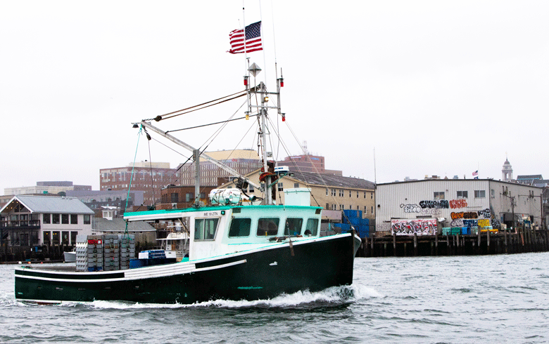 A fishing boat cruises past some of Portland's wharves. PHOTO: JACK SULLIVAN