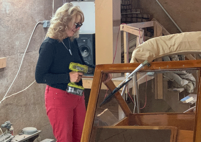 Kathy Walsh at work on her boat. PHOTO: COURTESY KATHY WALSH