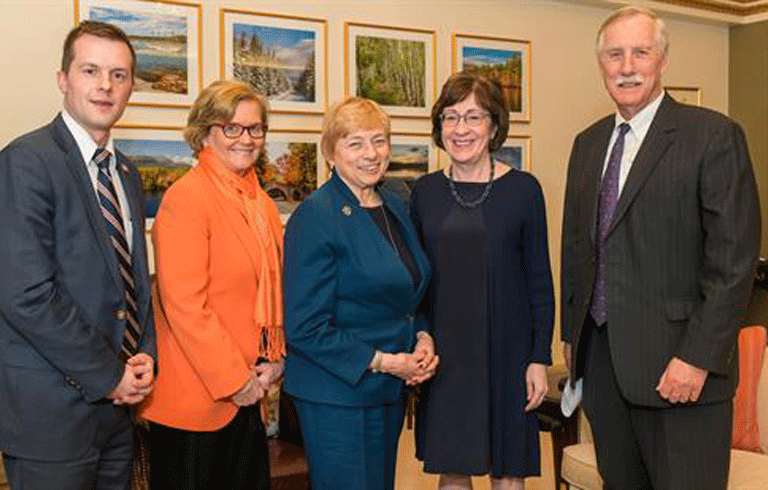 Maine's congressional delegation (from left, Jared Golden, Chellie Pingee, and from right, Angus King and Susan Collins, flank Gov. Janet Mills.