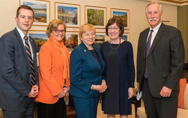 Maine's congressional delegation (from left, Jared Golden, Chellie Pingee, and from right, Angus King and Susan Collins, flank Gov. Janet Mills.