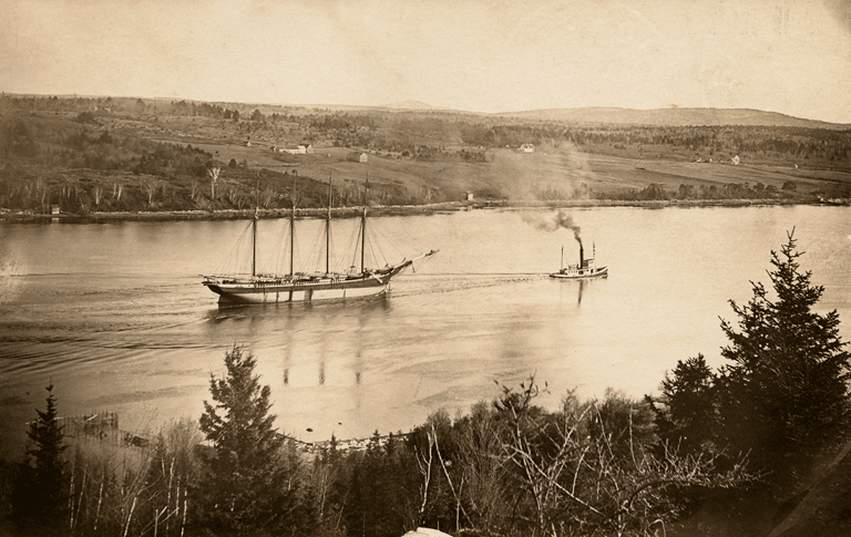 This image from the Captain William Abbott Collection at the Penobscot Marine Museum shows a schooner being towed by a tug.