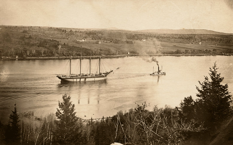 This image from the Captain William Abbott Collection at the Penobscot Marine Museum shows a schooner being towed by a tug.