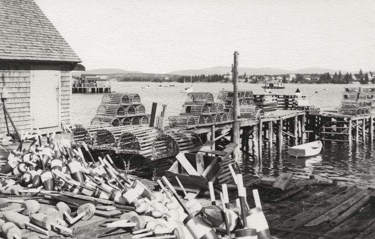 A lobster wharf at Bernard with a view across to Bass Harbor. Photo by Willis Humphreys Ballard (1906–1980). PHOTO: COURTESY SOUTHWEST HARBOR PUBLIC LIBRARY.