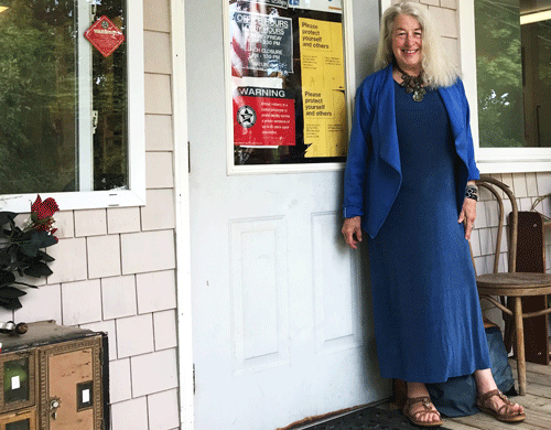 Sprague poses in front of the Islesford Post Office. PHOTO: COURTESY BARBARA FERNALD