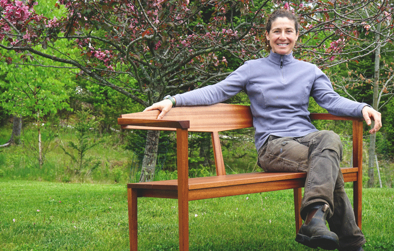 Christina Vincent poses on one of her benches. PHOTO: TOM GROENING