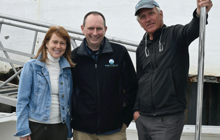 From left, Casco Baykeeper Ivy Frignoca, Executive Director Will Everitt, President of the Board of Directors of Friends of Casco Bay Andrew Marsters, standing on the deck of Friends' research vessel, R/V Joseph E. Payne.