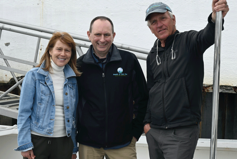 From left, Casco Baykeeper Ivy Frignoca, Executive Director Will Everitt, President of the Board of Directors of Friends of Casco Bay Andrew Marsters, standing on the deck of Friends' research vessel, R/V Joseph E. Payne.