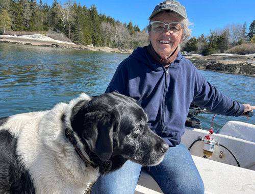 #1: Pam Cabañas, Pushed Off, 2022, compressed charcoal on Baltic birch panel, 36 by 48 inches. Photo Eli Cabañas #2: Cabañas in her skiff, the P/V (painting vessel) Skiffy with her dog Jesse in Friendship Harbor. Photo Jane Herbert