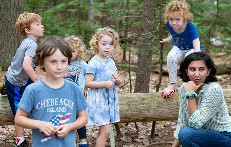 young woman teaches children