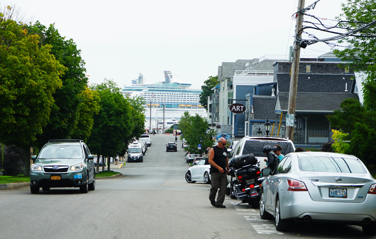 A cruise ship seems to loom over Bar Harbor's West Street. FILE PHOTO: TOM GROENING