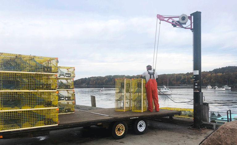 A lobsterman unloads his gear from his boat in Bar Harbor on a late October Sunday morning. PHOTO: TOM GROENING