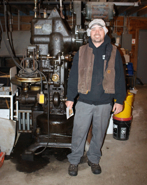 Simeon Allen stands next to an original sealer from the canning line at W.R. Allen’s processing plant in Orland. PHOTO: COURTESY KAYSIE LOGAN