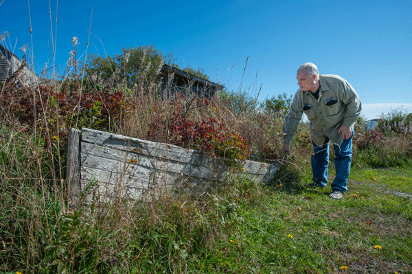 Buzz Scott examines the peapod his mother bought him 50 years ago.